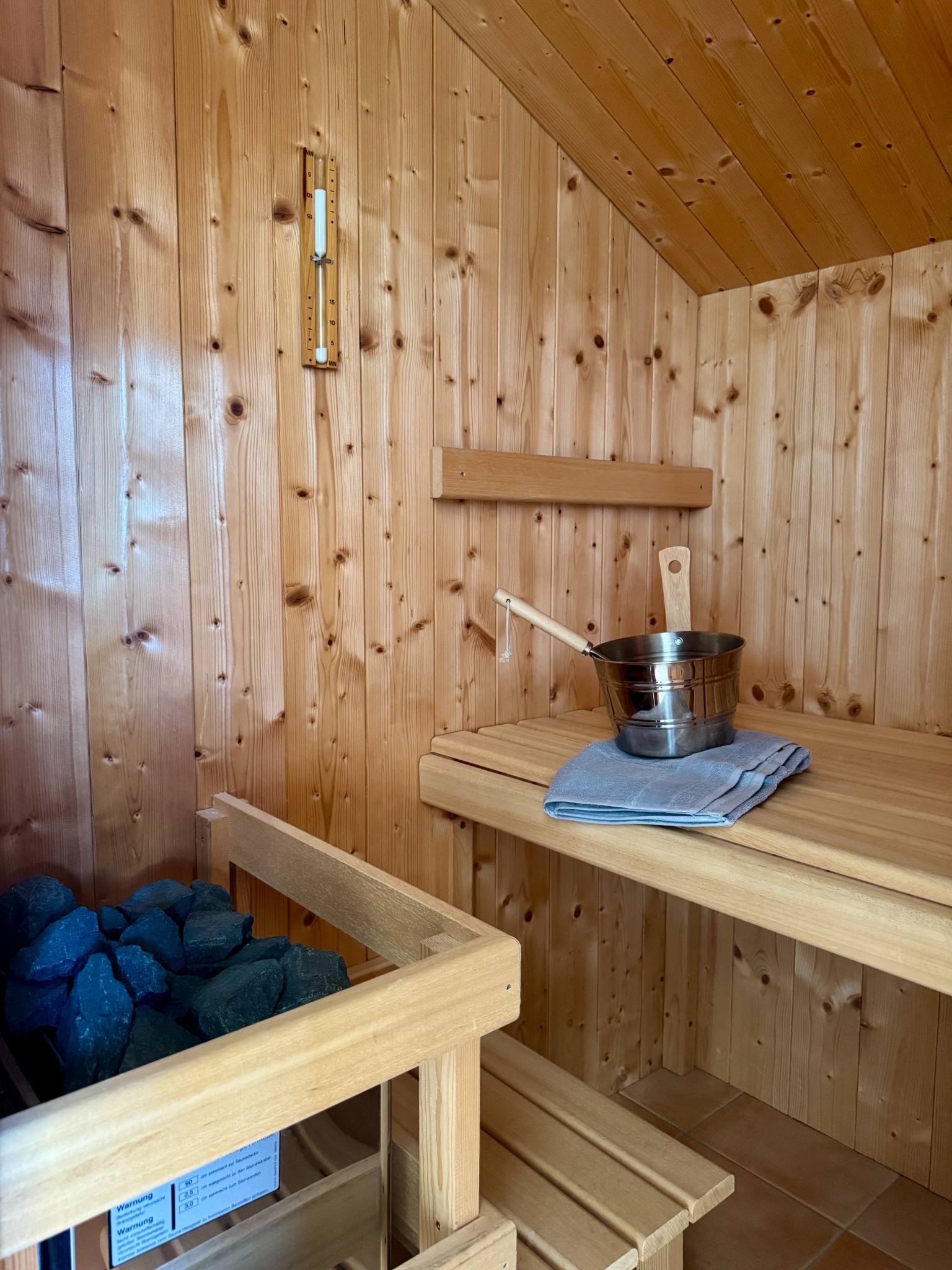Sauna mit Ofen und Holzbänken